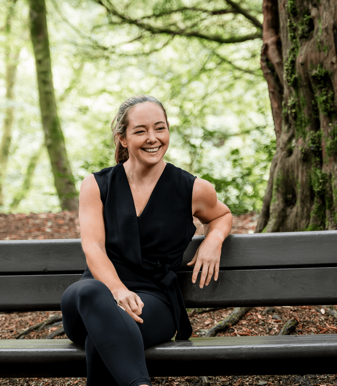 Diane Lillis, personal trainer from Move With Diane, taking a break on a bench in the forest