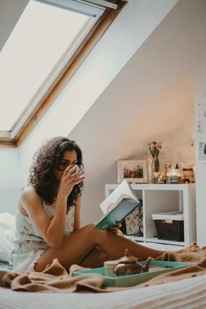 Self-care Sunday: A mom practicing mindfulness while reading and enjoying a hot beverage