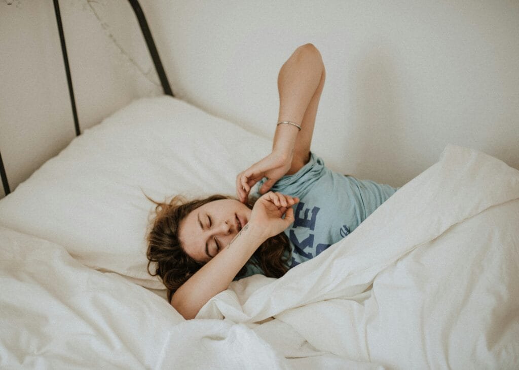 A burned out mum in her bed, feeling sleepy and tired