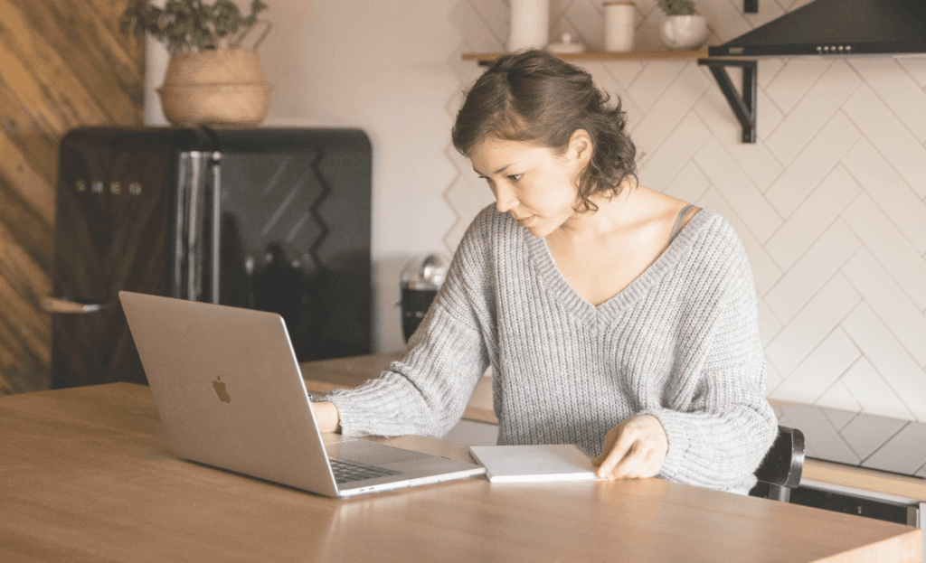 Female health coaching client working on laptop